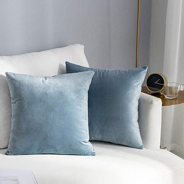 Two blue velvet throw pillows