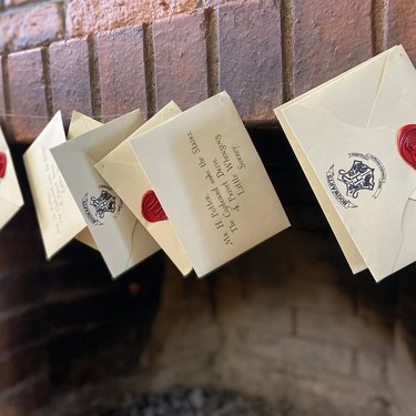 Hogwarts letters hanging from fireplace
