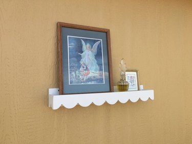 White floating shelf with scalloped edge