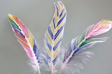 three feathers painted with paint markers