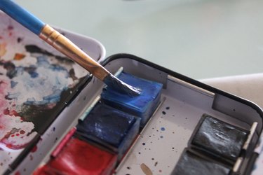 dipping wet brush in pigment
