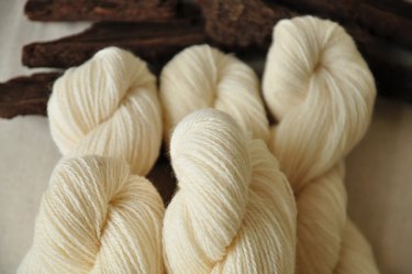 Three skeins of plain, undyed yarn