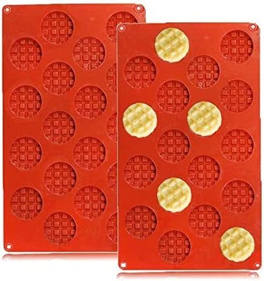 Two red silicone molds with 18 mini waffles