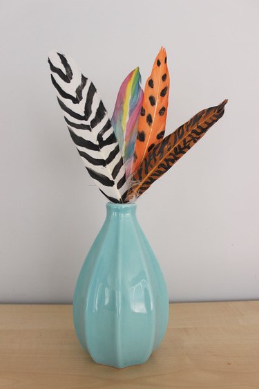 painted feathers in a vase