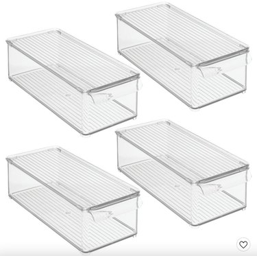 Four elongated clear plastic storage bins with lids and handles.