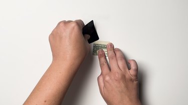 A single one-dollar bill folded three times