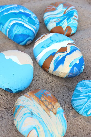 several paint pour rocks