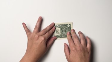 A single one-dollar bill folded in half