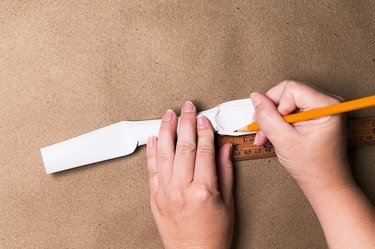 A rolled-up piece of white printer paper with coins inside