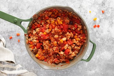 Cook tempeh, tomatoes, bell peppers, spices and olives