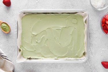 Spreading matcha yogurt on a baking sheet