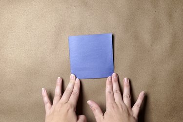 A folded smaller square of blue construction paper