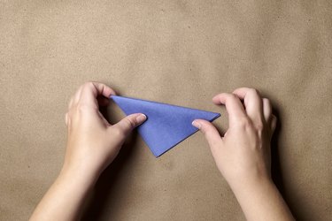 A small folded triangle of blue construction paper