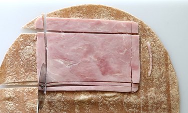 Slice tortilla and ham for textbook sandwiches