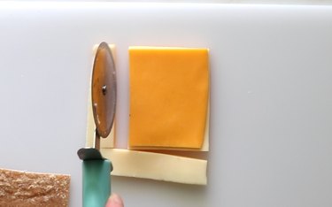 Slice cheese for textbook sandwiches