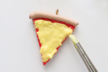 Adding yellow polymer clay to charms for pizza slice BFF necklaces