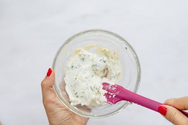 mixing basil goat cheese spread.