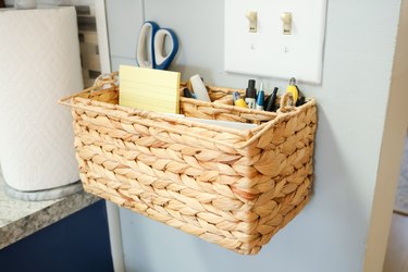 organized paper and pens in a hanging basket