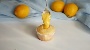 add lemon curd into cupcake centers