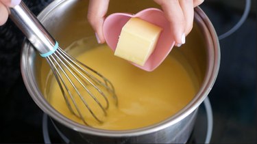 adding butter to lemon curd pot