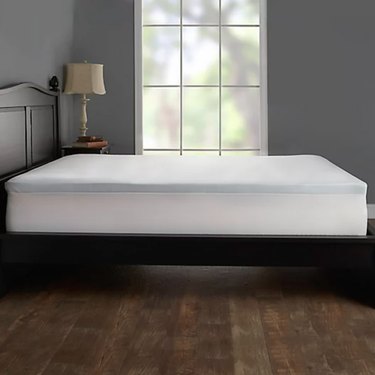 Light blue 2-inch memory foam topper on a bed in a gray bedroom.