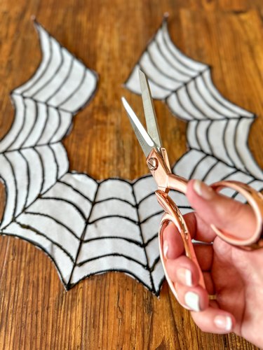 removing excess paper around spiderweb necklace