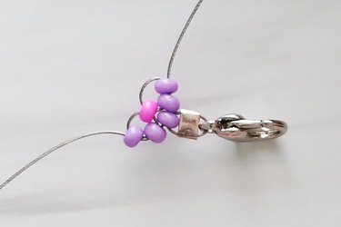 Purple and pink seed beads on wire for a daisy chain bracelet