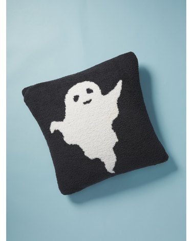Woven Ghost Pillow from HomeGoods that's ultra-plush, mostly black with a cute white ghost on it.