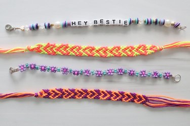 Letter bead, embroidery heart and beaded daisy chain friendship bracelets on a white background