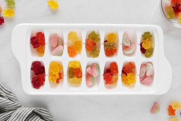 Add gummy candies to ice cube tray