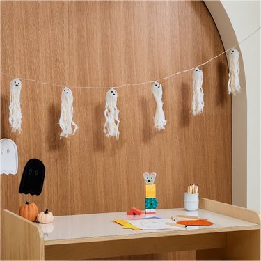 Light-Up Hanging Ghosts from West Elm. The ghosts have a whispy texture and cute faces.