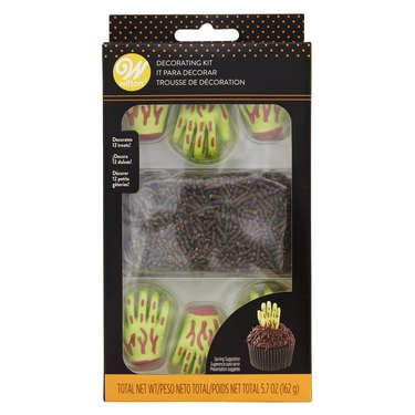 Zombie Hand Decorating Kit from Walmart. There are 12 green zombie hands with blood details and chocolate sprinkles.