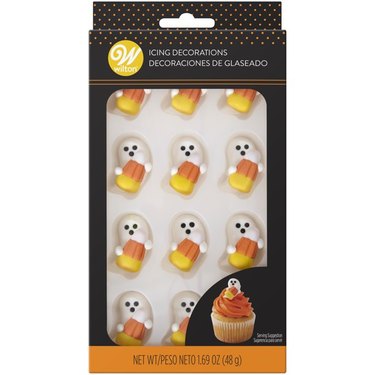 Ghost with Candy Corn Icing Decorations from Walmart. The ghosts are each holding a candy corn and there are 12 of them in a package.