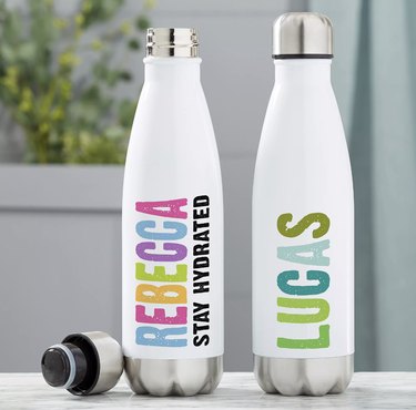 Two white water bottles that are personalized. One says "Rebecca Stay Hydrated" and the other says "Lucas."