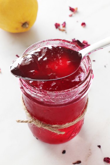 Rose petal jelly in jar and on spoon