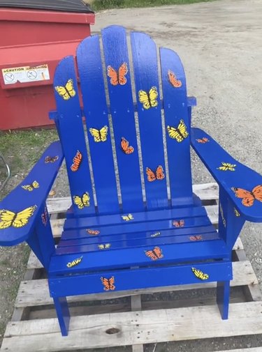 Blue Adirondack chair painted with yellow and orange butterflies