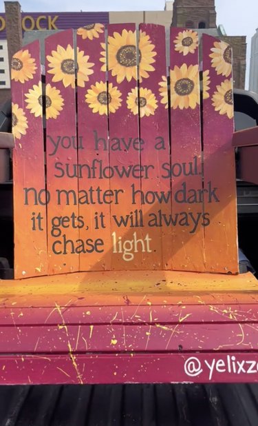 Pink, orange and yellow Adirondack chair with sunflowers and the quote "You have a sunflower soul. No matter how dark it gets, it will always chase light"