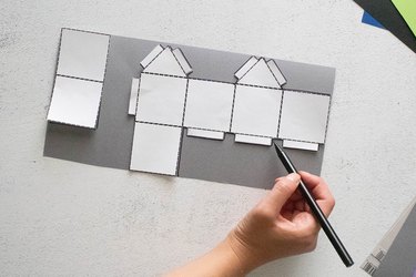 Tracing mini house template on gray paper