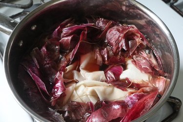 Red onion peels and white cotton boiling in a pot