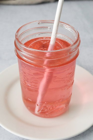 Dip lollipop stick in jar of pink sugar syrup