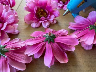using a hot glue gun to string flowers together