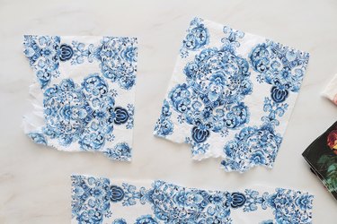 Tear decoupage napkin into smaller pieces