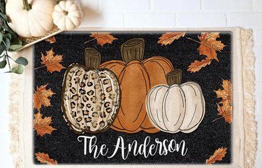 Three decorative pumpkins painted on black coir doormat, personalizes with The Andersons