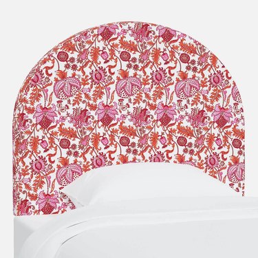Charging dorm room headboard in a bright floral pattern of pinks, reds, and oranges against a white backdrop.