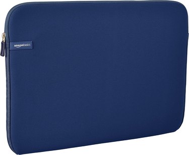 Navy slim laptop sleeve with a top zipper and a logo that says 'Amazon Basics.'