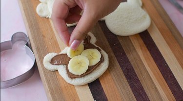 Adding banana slices to bread