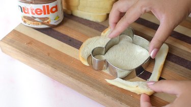 Peeling crust off bread slice