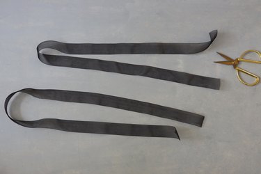 two long strands of black ribbon