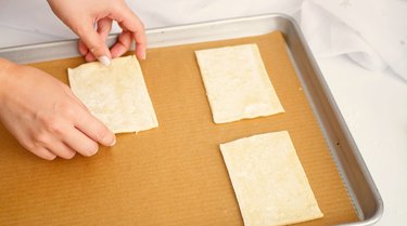 pastry rectangles being arranged on baking tray