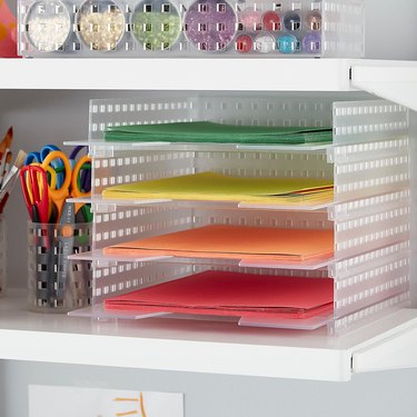 Multi-colored construction paper in four-shelf plastic organizer